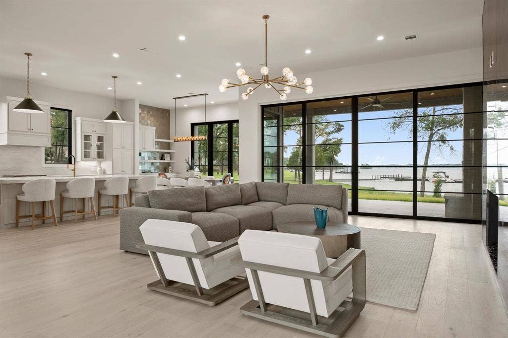 12121 Lighthouse Lane W, Malakoff, TX 75148 Living area with a chandelier, light wood-type flooring, a water view, recessed lighting, and plenty of natural light