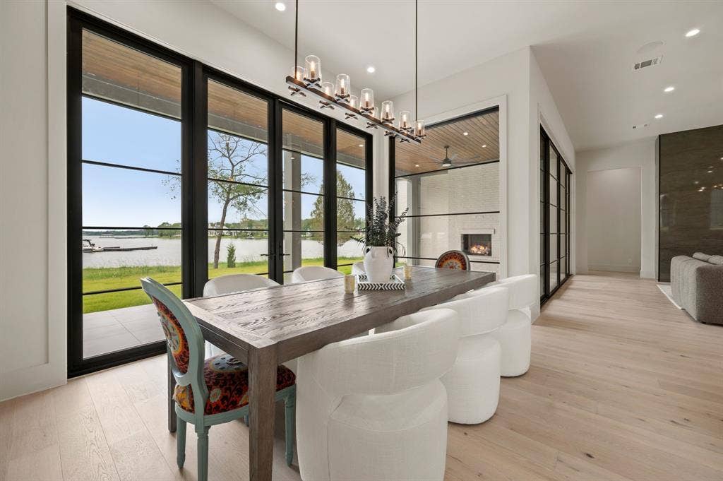 12121 Lighthouse Lane W, Malakoff, TX 75148 Dining area featuring a water view, a chandelier, light wood-type flooring, recessed lighting, and a fireplace