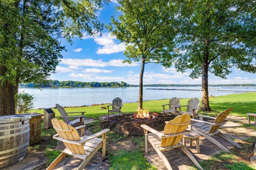 12121 Lighthouse Lane W, Malakoff, TX 75148 View of grassy yard featuring an outdoor fire pit and a water view
