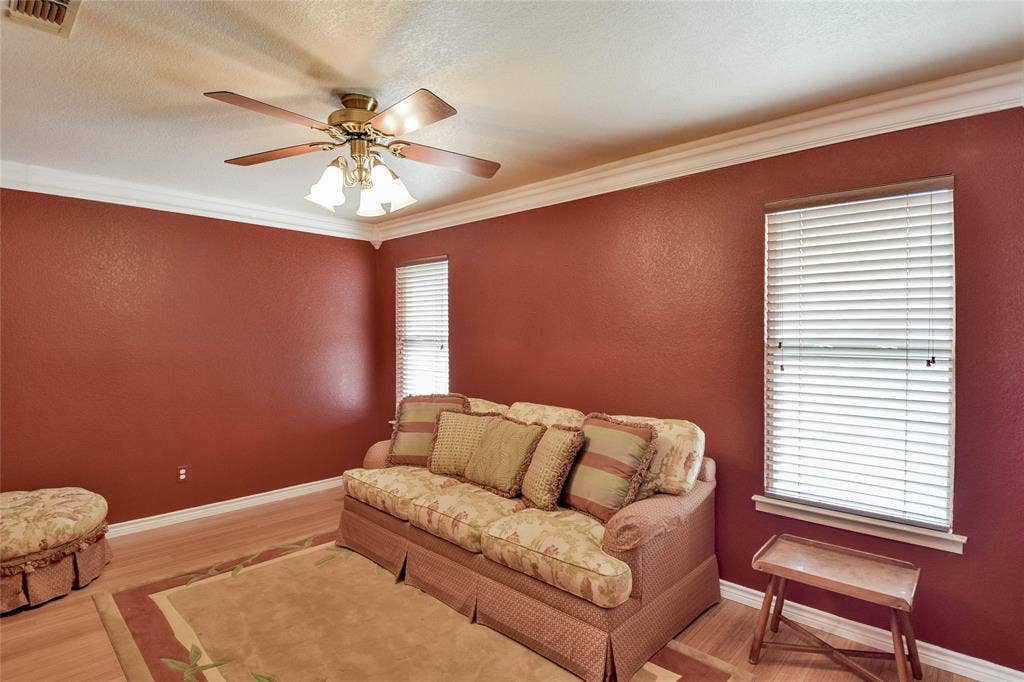 4009 Scenic Way, Granbury, TX 76049 Living area with ornamental molding, ceiling fan, wood finished floors, and baseboards