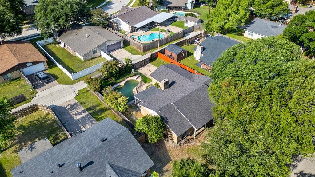 745 Oakland Street, Grand Prairie, TX 75052 Aerial view of property and surrounding area featuring a pool and nearby suburban area