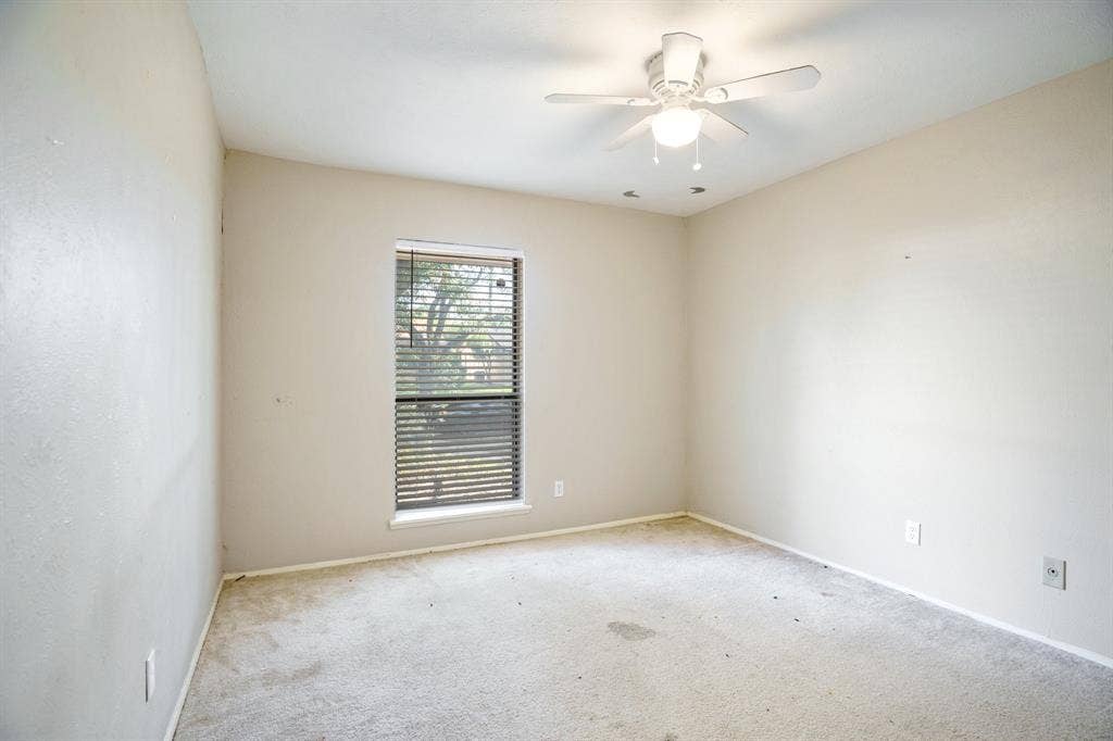 745 Oakland Street, Grand Prairie, TX 75052 Carpeted spare room with ceiling fan and baseboards