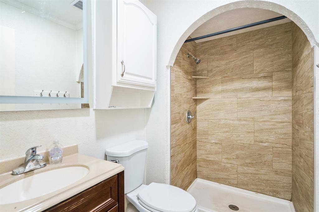745 Oakland Street, Grand Prairie, TX 75052 Full bath featuring toilet, vanity, and a tile shower