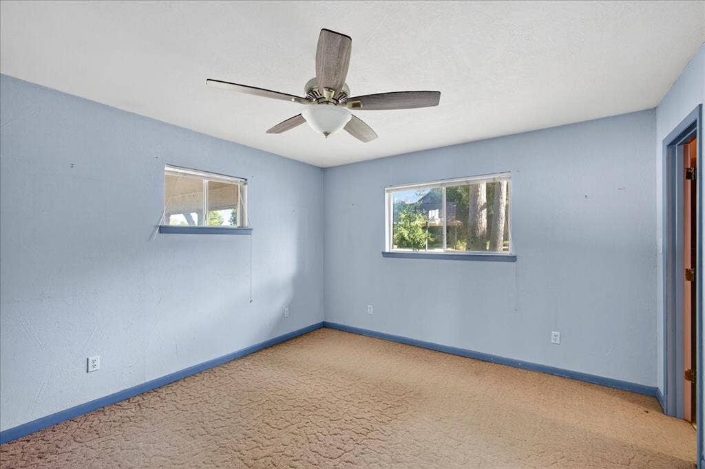 6903 Scott Street, Eustace, TX 75124 Carpeted empty room featuring plenty of natural light and ceiling fan