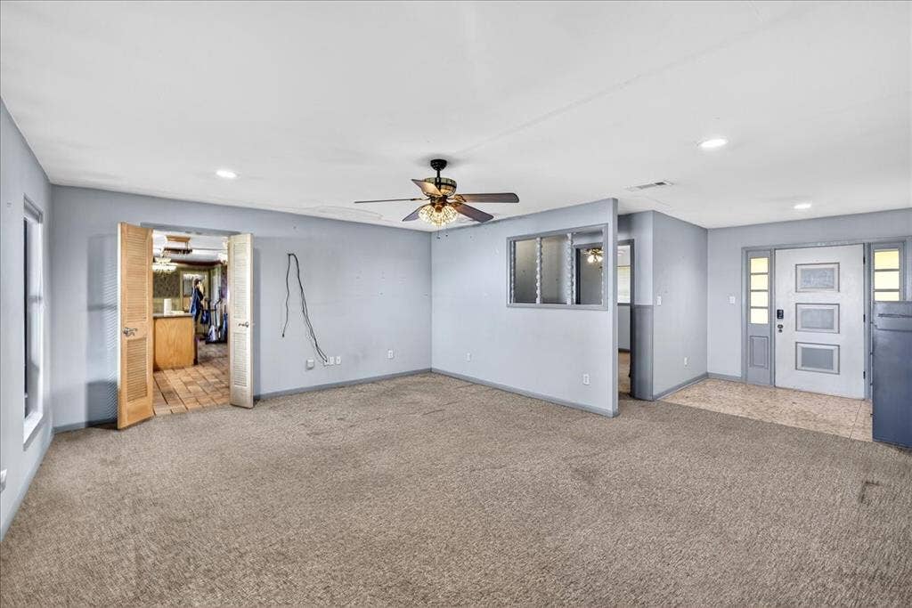 6903 Scott Street, Eustace, TX 75124 Unfurnished living room featuring carpet floors, a ceiling fan, and recessed lighting