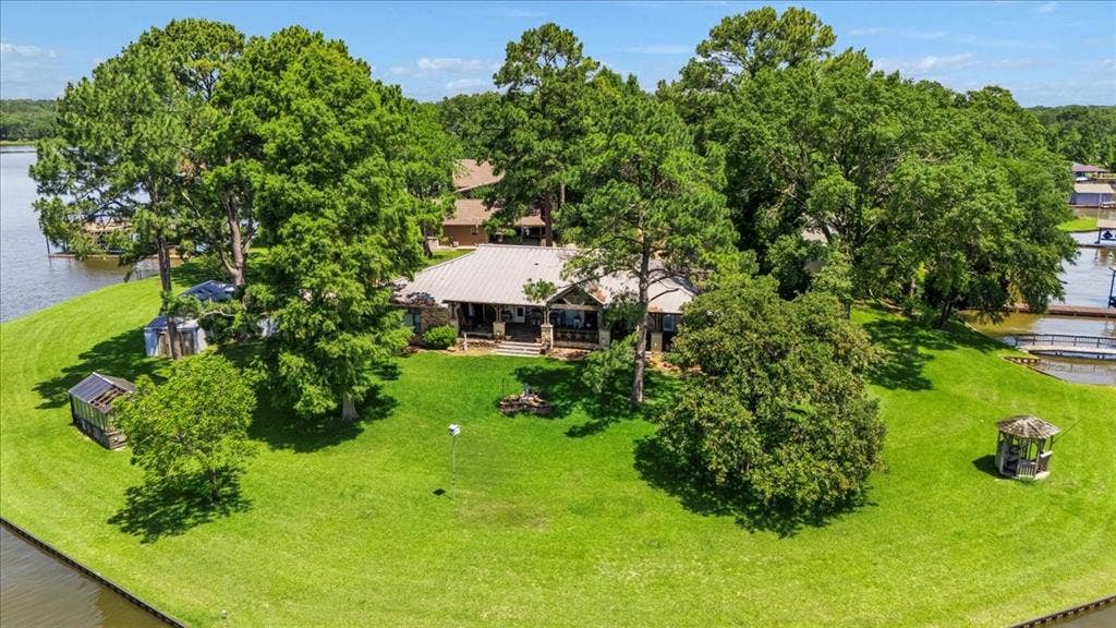 6903 Scott Street, Eustace, TX 75124 View of subject property featuring a large body of water and a tree filled landscape