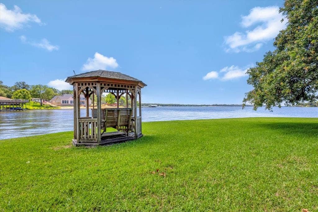 6903 Scott Street, Eustace, TX 75124 Dock featuring a gazebo, a water view, and a lawn