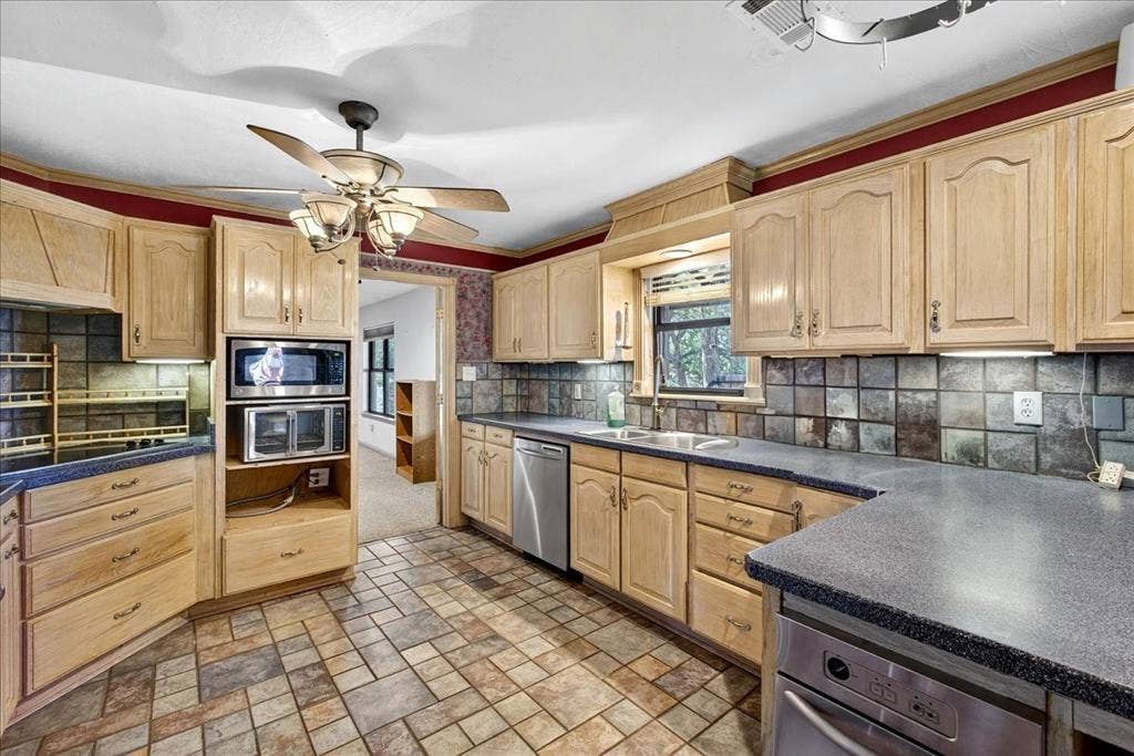6903 Scott Street, Eustace, TX 75124 Kitchen featuring stainless steel appliances, light brown cabinetry, and dark countertops