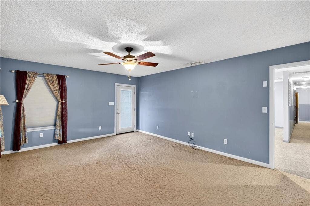 6903 Scott Street, Eustace, TX 75124 Spare room with carpet, a ceiling fan, and a textured ceiling