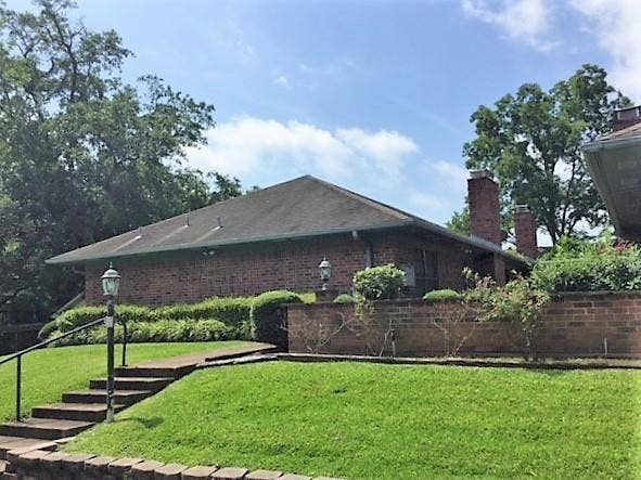 500 E College Street, #A2, Athens, TX 75751 View of side of property with a yard, a chimney, and brick siding