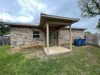 507 E Bryson Street, #A, Athens, TX 75751 Rear view of house featuring a patio area and brick siding