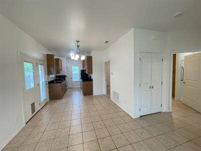 507 E Bryson Street, #A, Athens, TX 75751 Kitchen featuring light tile patterned flooring, a chandelier, healthy amount of natural light, and baseboards