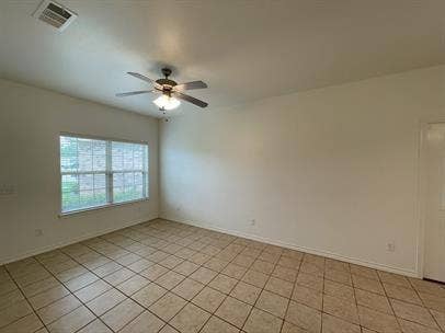 507 E Bryson Street, #A, Athens, TX 75751 Unfurnished room featuring ceiling fan, light tile patterned floors, and baseboards