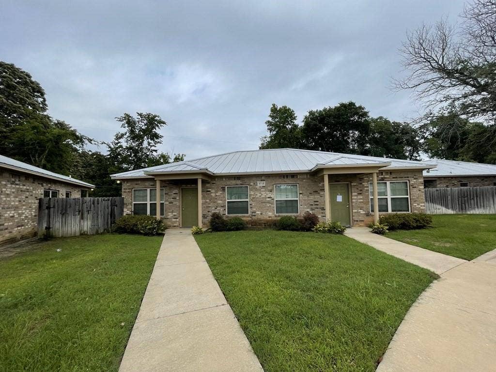507 E Bryson Street, #A, Athens, TX 75751 View of front facade featuring brick siding and metal roof