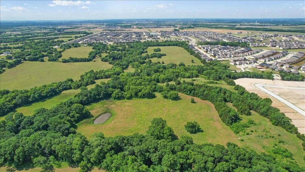 4196 County Road 1001, McKinney, TX 75071 Aerial View of the land at 4195 CR 1001 that butts up against the Subdivision - Eastridges New Phase.