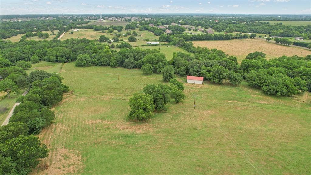 4196 County Road 1001, McKinney, TX 75071 Overview of rural landscape featuring a tree filled landscape and a pastoral area