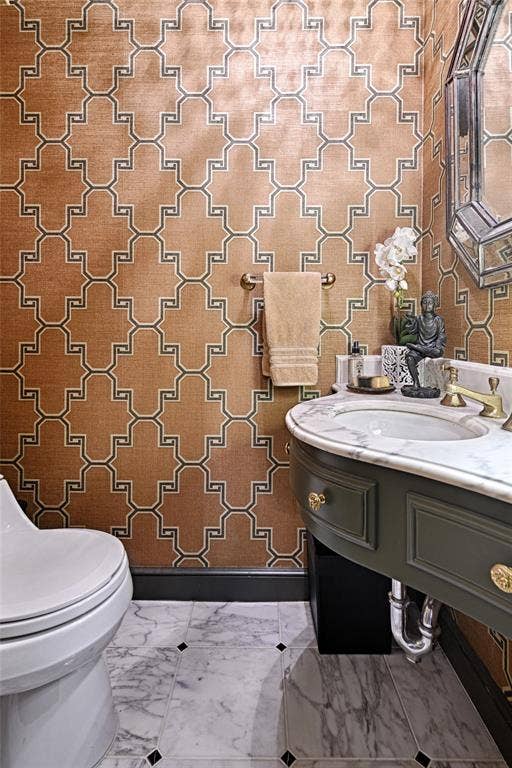 3525 Turtle Creek Boulevard, #4E, Dallas, TX 75219 Powder room for guests featuring wallpapered walls, marble tile flooring, and vanity