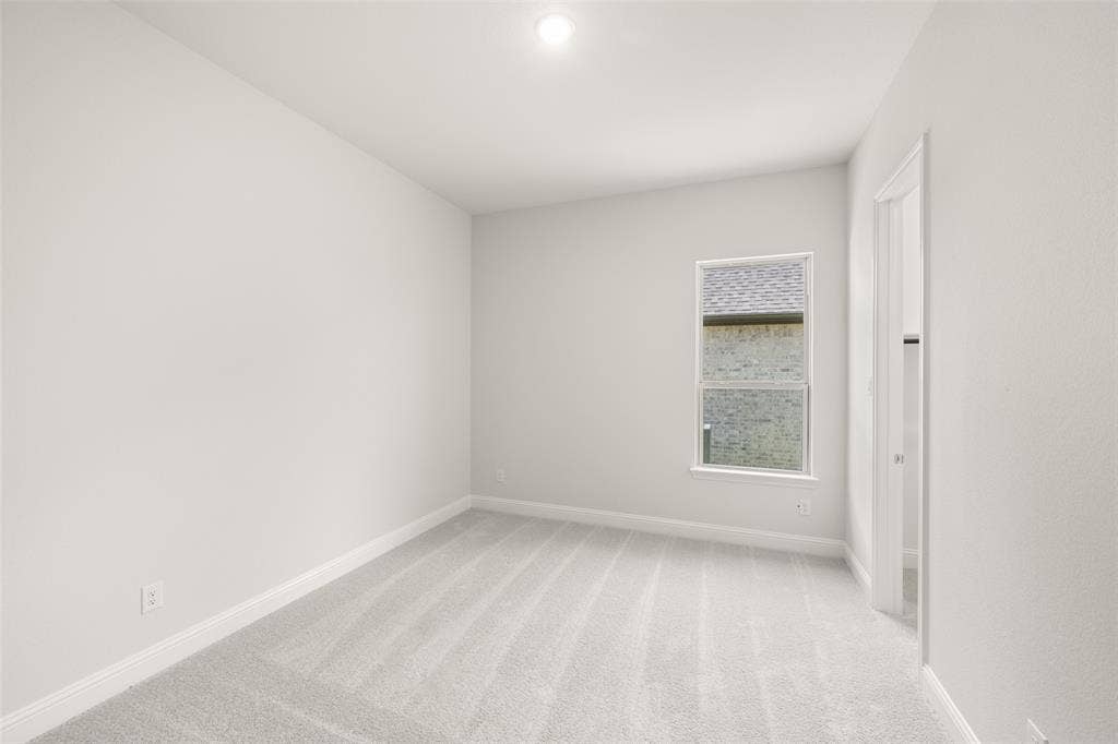 413 Wabash Drive, Waxahachie, TX 75167 Empty room with baseboards and light colored carpet