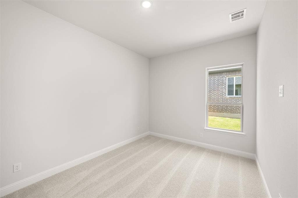 413 Wabash Drive, Waxahachie, TX 75167 Empty room featuring light colored carpet and recessed lighting