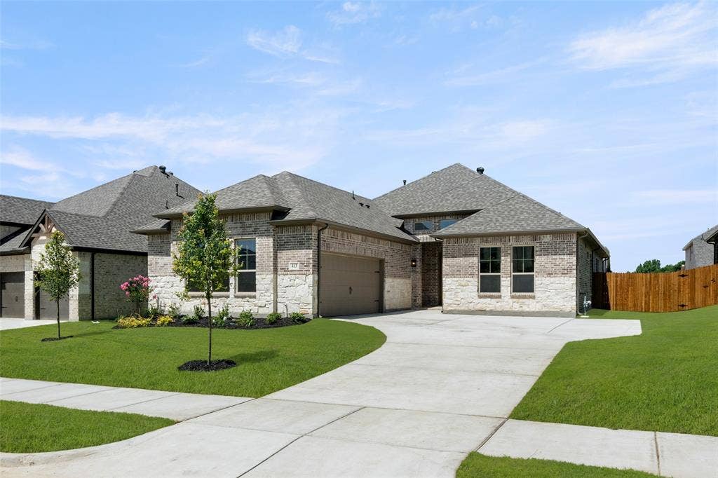 413 Wabash Drive, Waxahachie, TX 75167 French country inspired facade with roof with shingles, brick siding, driveway, and a garage