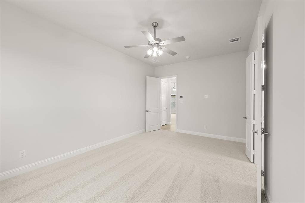 413 Wabash Drive, Waxahachie, TX 75167 Unfurnished bedroom with light colored carpet and ceiling fan