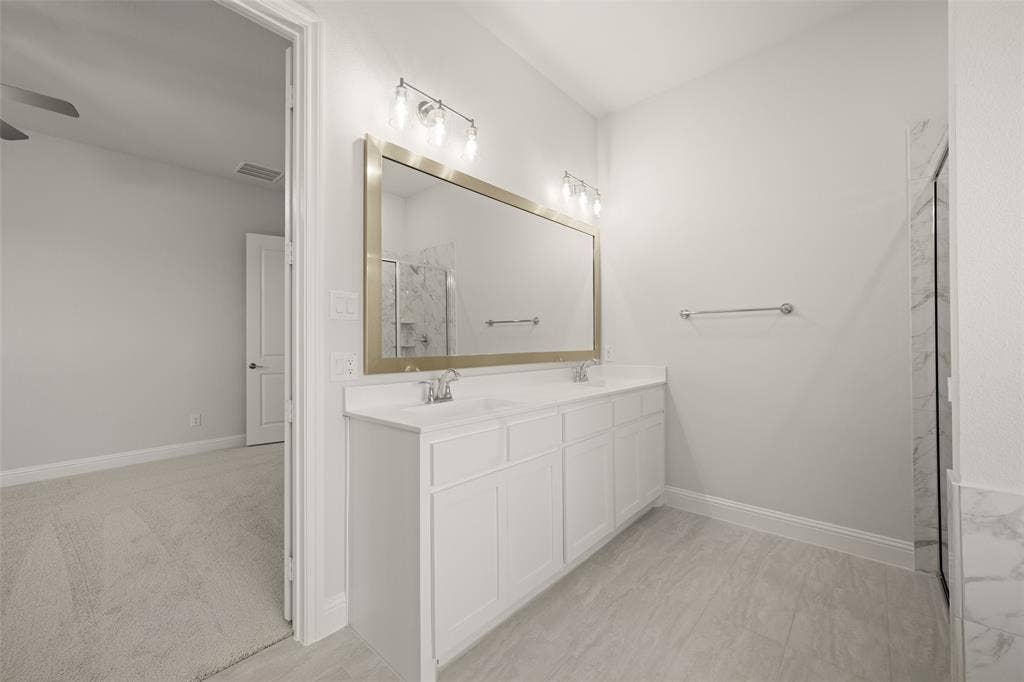 413 Wabash Drive, Waxahachie, TX 75167 Full bath featuring a ceiling fan, a marble finish shower, and double vanity