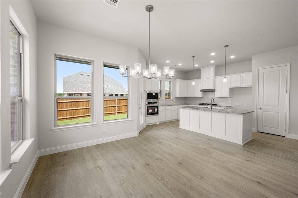 413 Wabash Drive, Waxahachie, TX 75167 Kitchen featuring light wood-style floors, white cabinets, recessed lighting, backsplash, and pendant lighting