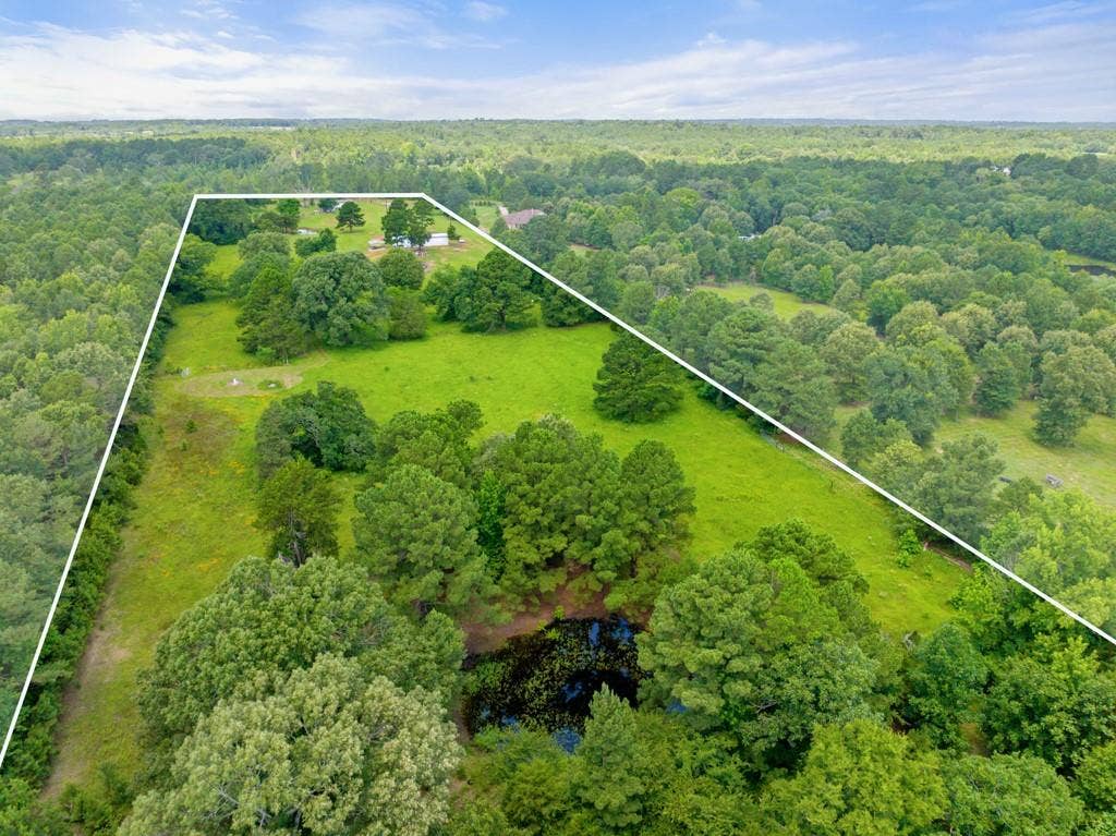 5353 CR 385, Tyler, TX 75708 Aerial overview of property's location with property parcel outlined and a forest