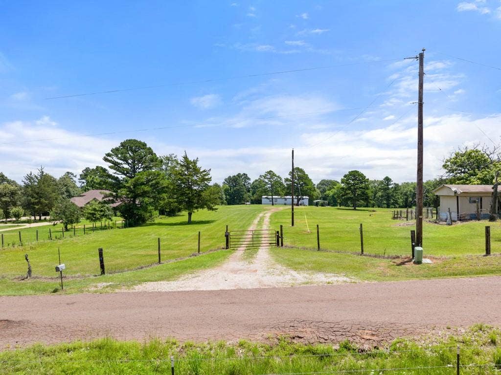 5353 CR 385, Tyler, TX 75708 View of road featuring a gate and a rural view