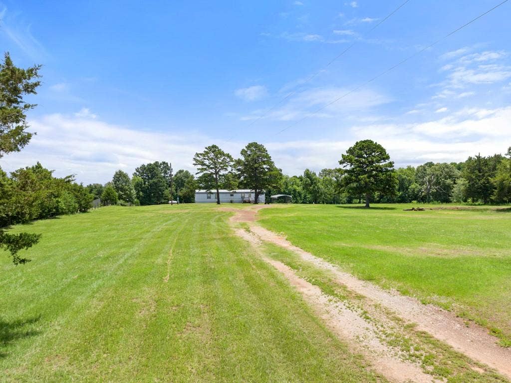 5353 CR 385, Tyler, TX 75708 View of green lawn featuring driveway
