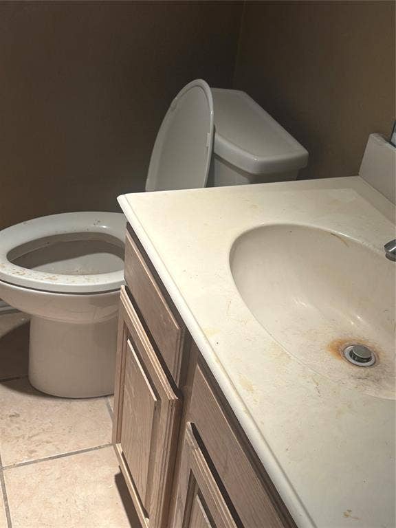 Bathroom vanity with a white countertop and integrated sink, complemented by a light wood-finish cabinet
