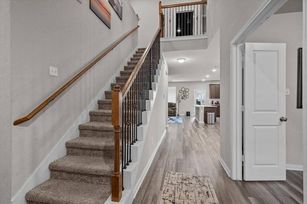 3501 Beutel Road, Waco, TX 76655 Staircase with wood finished floors and a high ceiling