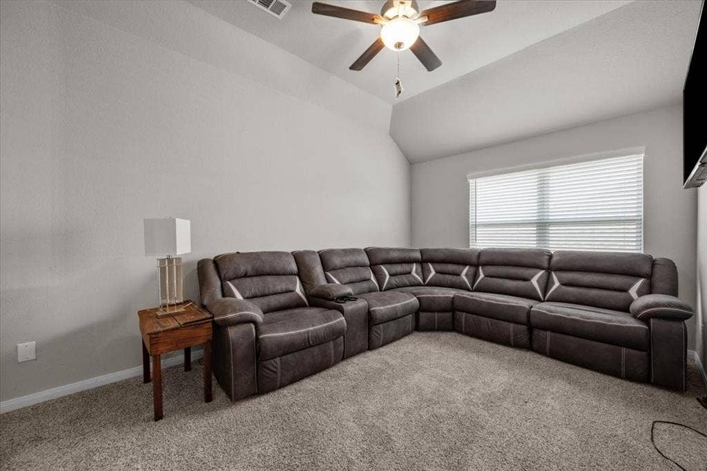 3501 Beutel Road, Waco, TX 76655 Living area featuring carpet, lofted ceiling, and a ceiling fan