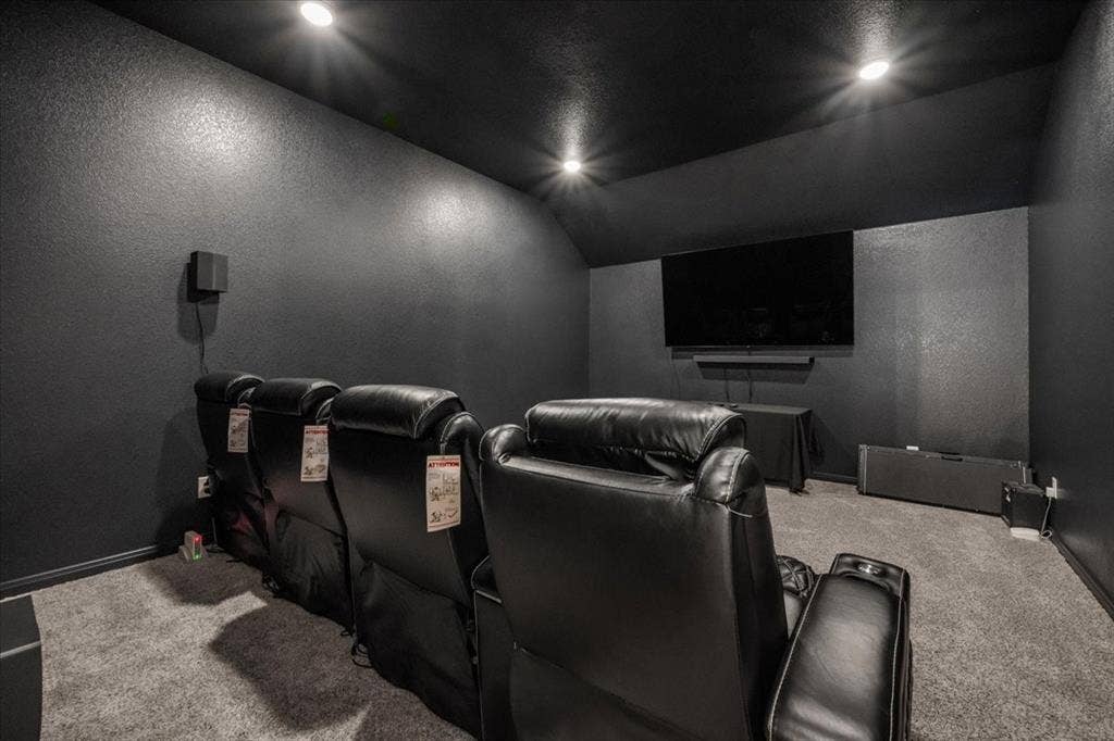 3501 Beutel Road, Waco, TX 76655 Home theater room featuring a textured wall, lofted ceiling, and carpet floors