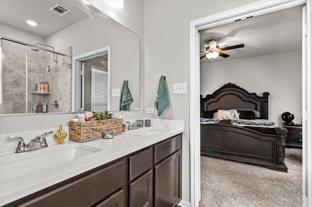 3501 Beutel Road, Waco, TX 76655 Full bathroom featuring ensuite bathroom, double vanity, tiled shower, and ceiling fan