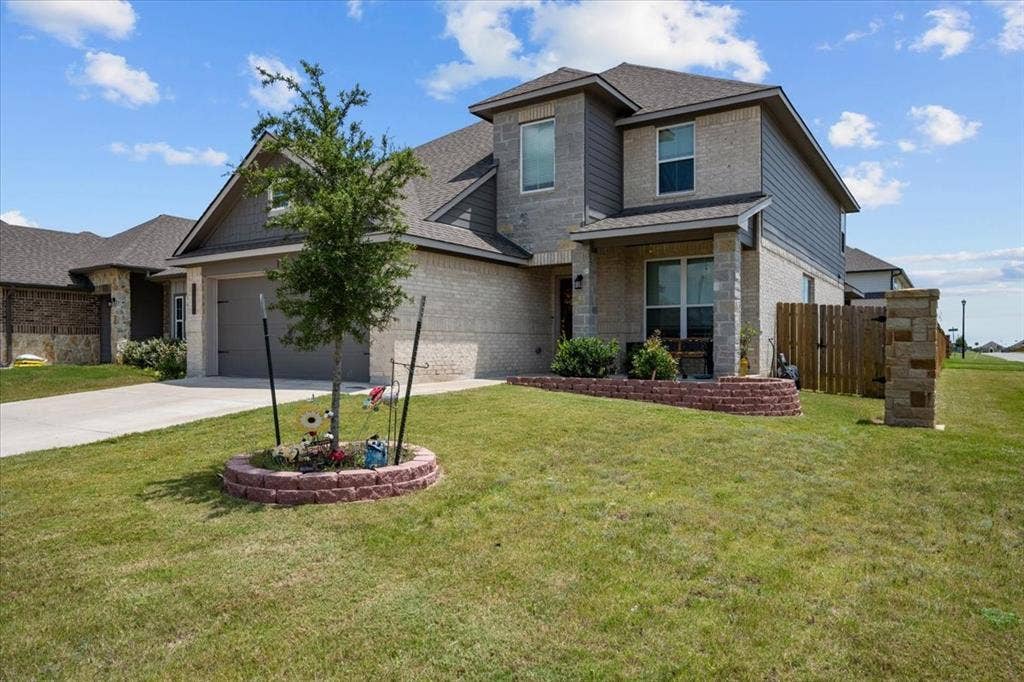 3501 Beutel Road, Waco, TX 76655 View of front of property with driveway, brick siding, an attached garage, and a shingled roof