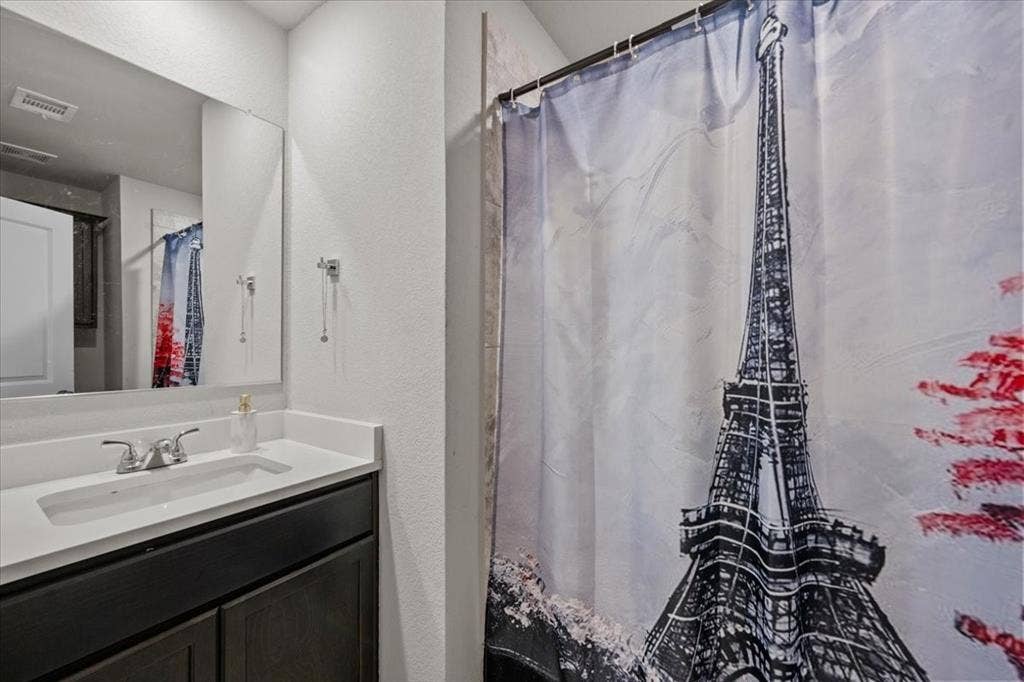 3501 Beutel Road, Waco, TX 76655 Full bathroom featuring vanity, a textured wall, and a shower with shower curtain