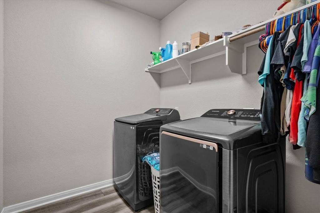 3501 Beutel Road, Waco, TX 76655 Laundry area with separate washer and dryer and wood finished floors