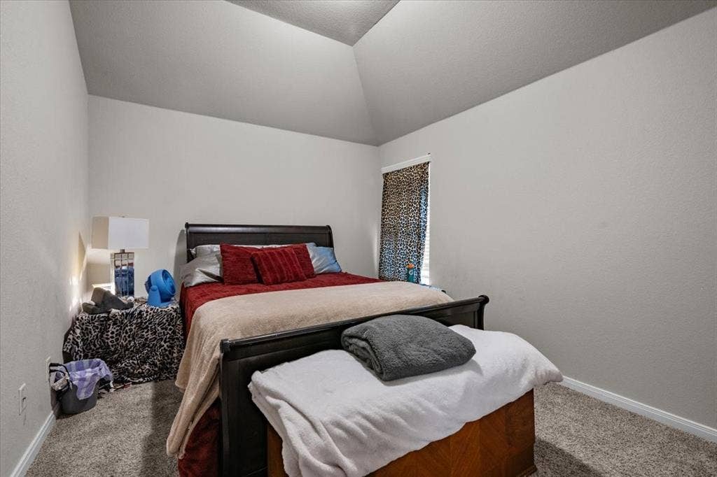 3501 Beutel Road, Waco, TX 76655 Carpeted bedroom featuring baseboards and lofted ceiling