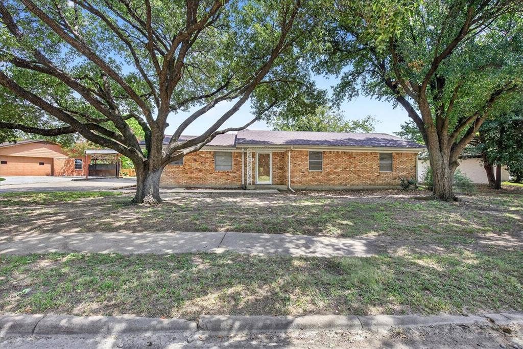 Ranch-style home featuring brick siding