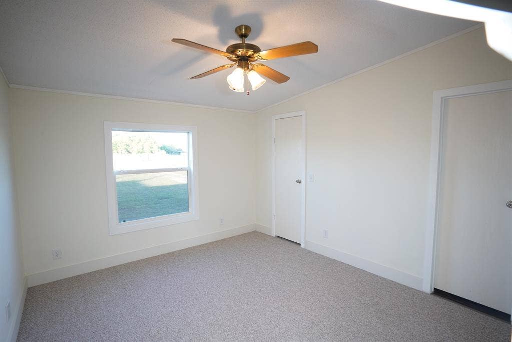 245 Oak Hill Court, Waxahachie, TX 75167 Empty room with ornamental molding, carpet, and ceiling fan