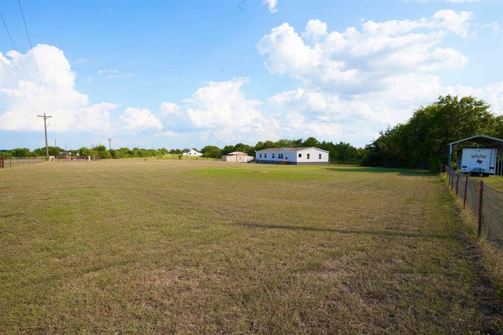 245 Oak Hill Court, Waxahachie, TX 75167 View of yard with a view of rural / pastoral area and a carport