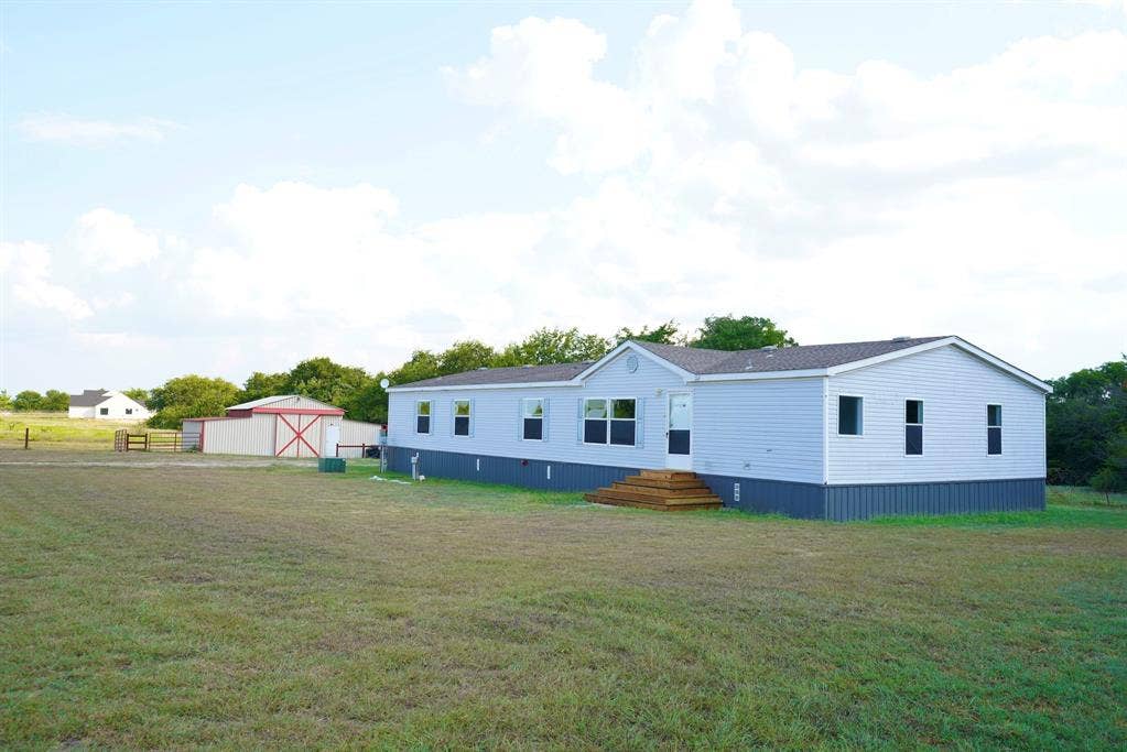 245 Oak Hill Court, Waxahachie, TX 75167 Back of house with an outbuilding and a detached garage