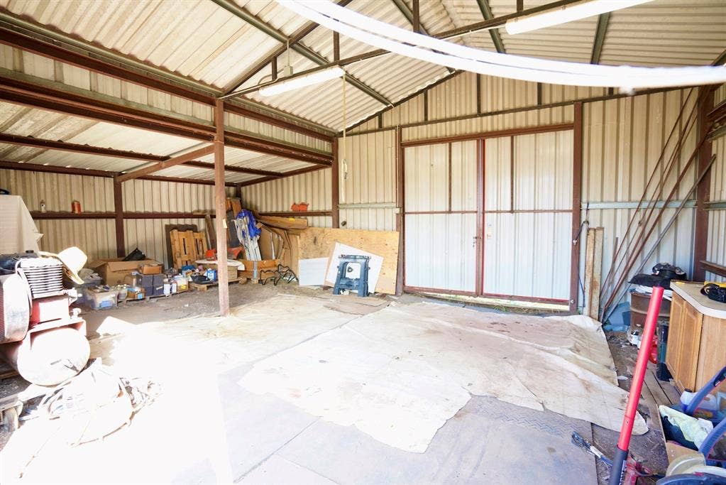 245 Oak Hill Court, Waxahachie, TX 75167 Garage featuring metal wall
