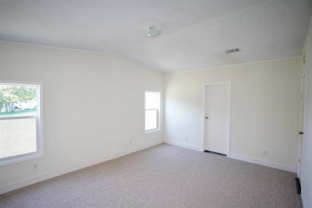 245 Oak Hill Court, Waxahachie, TX 75167 Spare room with carpet floors, lofted ceiling, and ornamental molding