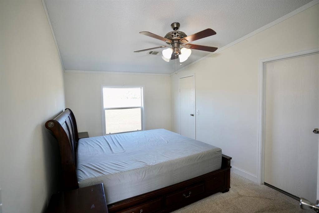 245 Oak Hill Court, Waxahachie, TX 75167 Carpeted bedroom with ornamental molding and a ceiling fan