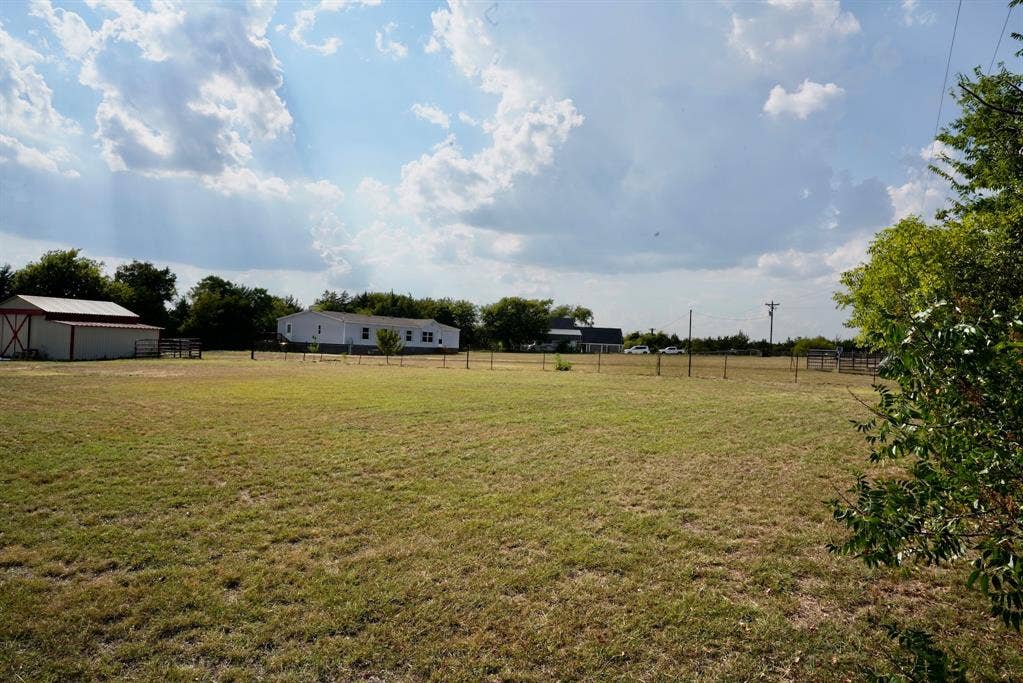 245 Oak Hill Court, Waxahachie, TX 75167 View of yard featuring a rural view and an outdoor structure