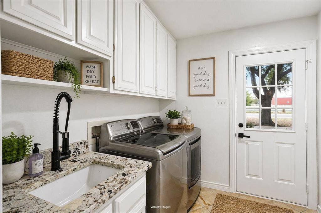 Laundry room on the 1st floor, 3 laundry chutes from above. Has its own exterior door for a mud room entry, built in cabinetry and a drip-dry area