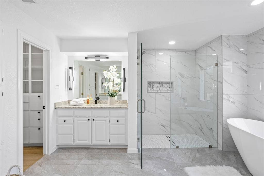 Gorgeous primary bathroom with 2 separate walk-in closets. Coveted set up