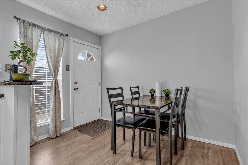 1349 S 11th Street, Waco, TX 76706 Dining space featuring a textured ceiling and light wood-style flooring